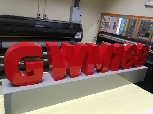 ตัวอักษรสามมิติสีแดง GWM168 บนโต๊ะผลิตในโรงงานทำป้าย